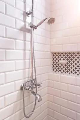 a shower in a bathroom with white tiles at Chez Marie - Cozy One-Bedroom with Balcony by Flat Mаnager in Sofia