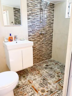 a bathroom with a toilet and a sink and a shower at CENTER APARTMENT PLOVDIV in Plovdiv