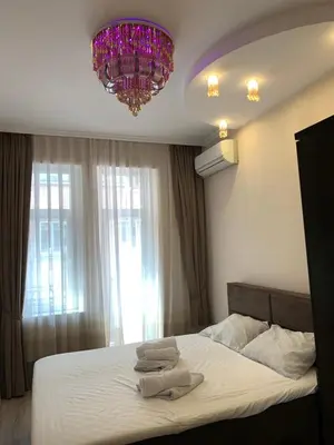 a bedroom with a bed with two towels on it at CENTER APARTMENT PLOVDIV in Plovdiv