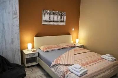 a bedroom with a bed with two towels on it at Guest Apartment Balkan in Karlovo