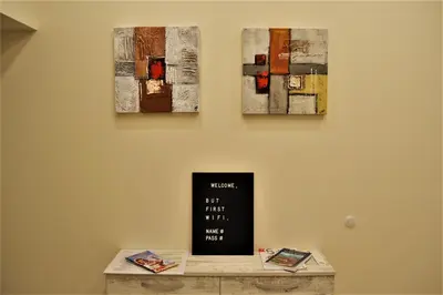 a room with three paintings hanging on a wall at Guest Apartment Balkan in Karlovo