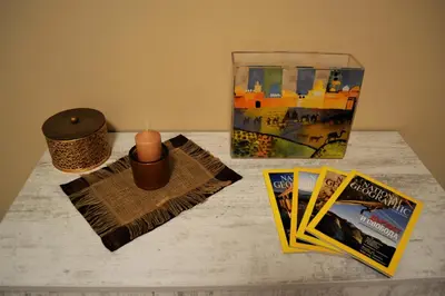 a table with a candle and magazines and a box at Guest Apartment Balkan in Karlovo
