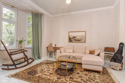 a living room with a couch and a chair at Spacious vintage 2BR, 2bath apartment by Flat Mаnager in Sofia