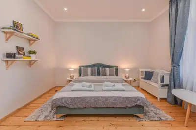 a bedroom with a bed with two towels on it at Spacious vintage 2BR, 2bath apartment by Flat Mаnager in Sofia