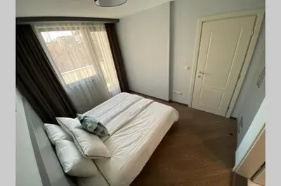 a bedroom with a bed with a pillow and a window at LUX 1BD/1BA City Center Apartment in Blagoevgrad