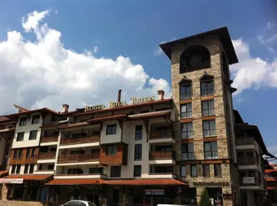 a building with a clock tower on top of it at Апартамент в комплекс Bansko Royal Towers in Bansko