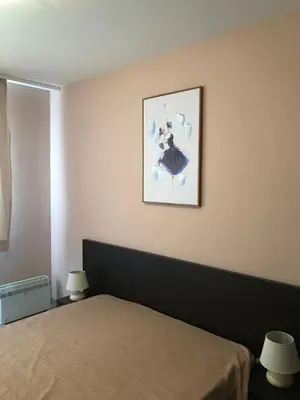 a bedroom with a bed and a picture on the wall at Апартамент в комплекс Bansko Royal Towers in Bansko
