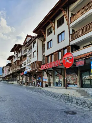 a street in front of a building with a stop sign at Апартамент в комплекс Bansko Royal Towers in Bansko