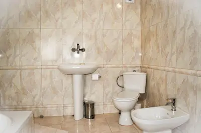 a bathroom with a toilet and a sink at Casafamiglia in Prolesha