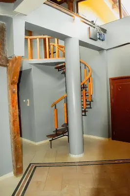 a room with a spiral staircase in a building at Casafamiglia in Prolesha