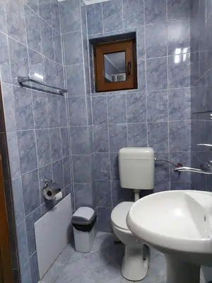 a bathroom with a toilet and a sink at Вила Сладък Живот in Tsigov Chark