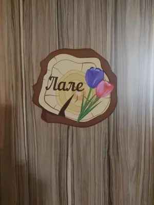 a sign on a wooden table with flowers on it at Вила Сладък Живот in Tsigov Chark