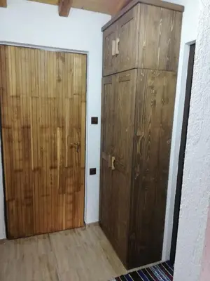 a pair of wooden doors in a room at GUEST HOUSE ELENA in Kosovo