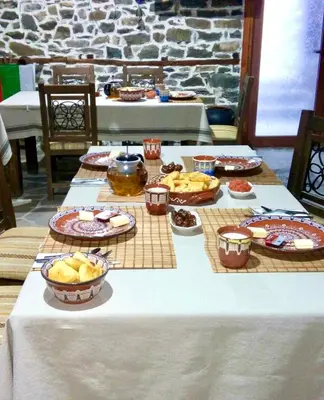 a table with many plates of food on it at GUEST HOUSE ELENA in Kosovo