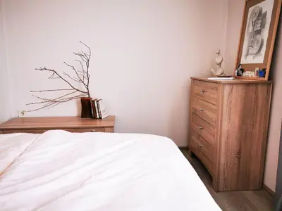 a bedroom with a bed and a wooden dresser at So Close Kapana - 2 Rooms Central Apartments in Plovdiv
