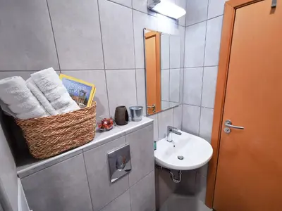 a bathroom with a sink and a mirror at So Close Kapana - 2 Rooms Central Apartments in Plovdiv