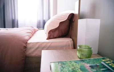 a bedroom with a bed and a table and a window at So Close Kapana - 2 Rooms Central Apartments in Plovdiv