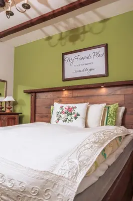 a bedroom with a large bed with a wooden headboard at 