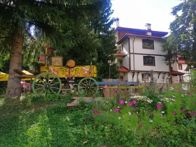 a yellow horse drawn carriage in front of a house at 