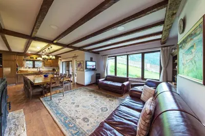 a living room with a couch and a table at Stoykite-Pamporovo Nature Retreat in Stoykite