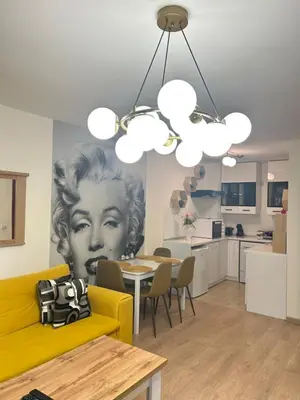 a living room with a painting of a woman on the wall at Sandanski Apartments Top Center in Sandanski