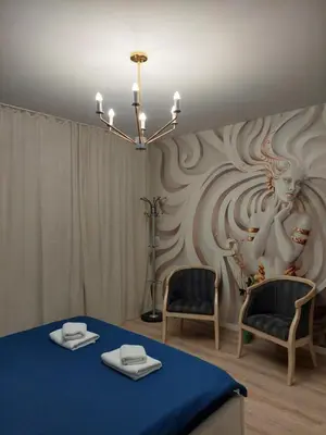 a room with a table and two chairs and a wall at Sandanski Apartments Top Center in Sandanski