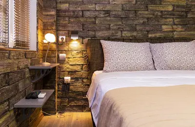 a bedroom with a bed and a brick wall at 1BD Apartment - 5 mins to the city centre by Flat Mаnager in Plovdiv