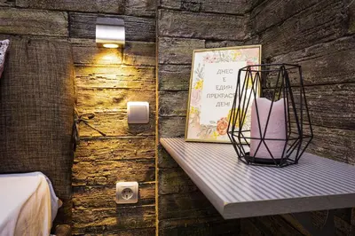 a wall with a shelf with a picture and a candle at 1BD Apartment - 5 mins to the city centre by Flat Mаnager in Plovdiv