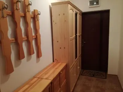 a room with a wooden cabinet and a door at Вила Хоризонт in Tsigov Chark