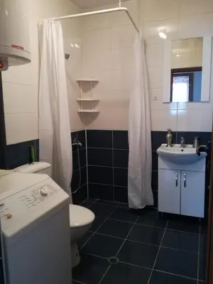 a bathroom with a toilet and a sink and a shower at Вила Хоризонт in Tsigov Chark