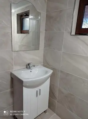 a bathroom with a sink and a mirror at Вила Хоризонт in Tsigov Chark