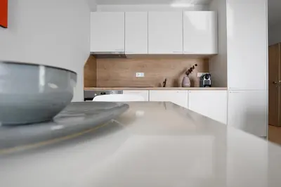 a kitchen with white cabinets and a counter top at Connect Living Apartments in Sofia