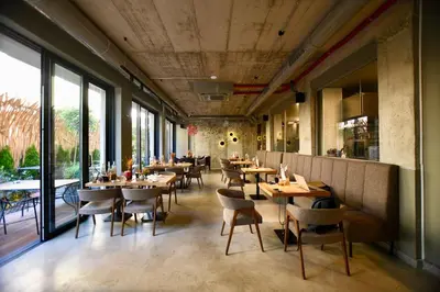 a restaurant with wooden tables and chairs and windows at Connect Living Apartments in Sofia
