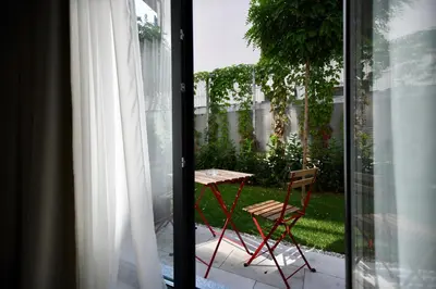 a table and a chair outside a window at Connect Living Apartments in Sofia