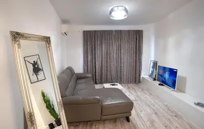 a living room with a couch and a mirror at Beautiful Place in The Heart of The City!!!! in Plovdiv
