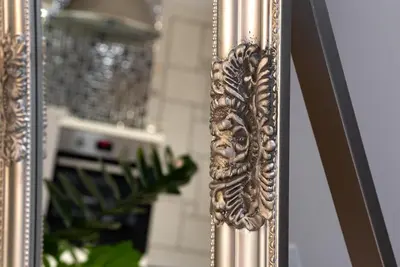 a mirror with a gold frame with a reflection in it at Beautiful Place in The Heart of The City!!!! in Plovdiv