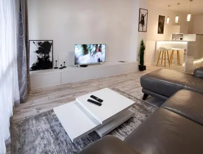 a living room with a couch and a tv on a wall at Beautiful Place in The Heart of The City!!!! in Plovdiv