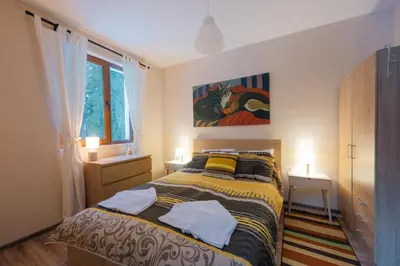 a bedroom with a bed with two towels on it at Max Holiday Apartment in Pamporovo