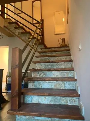 a set of stairs in a house with a metal railing at Guest House Kalina in Sapareva Banya
