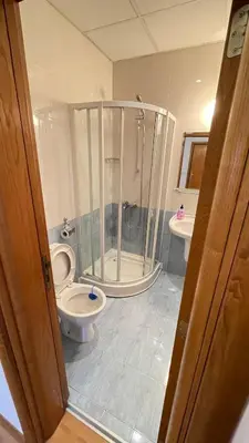 a bathroom with a shower and a toilet and a sink at Two bedroom flat in Magernitsa in Bansko
