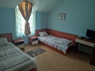 a small bedroom with two beds and a window at Хотелски Комплекс Авалон in Asenovgrad