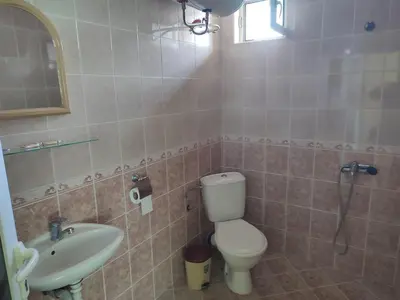 a bathroom with a toilet and a sink at Хотелски Комплекс Авалон in Asenovgrad