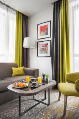 a living room with a table with food on it at Hotel Jägerhof in Plovdiv