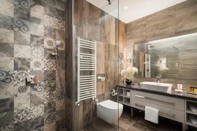 a bathroom with a sink and a toilet and a mirror at Hotel Jägerhof in Plovdiv