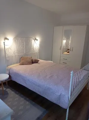 a bedroom with a large bed and a table at Комплекс Падалото 