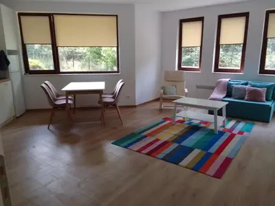 a living room with a couch and a table at Комплекс Падалото 