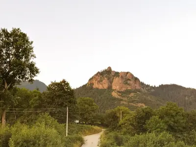 a dirt road with a mountain in the background at Комплекс Падалото 