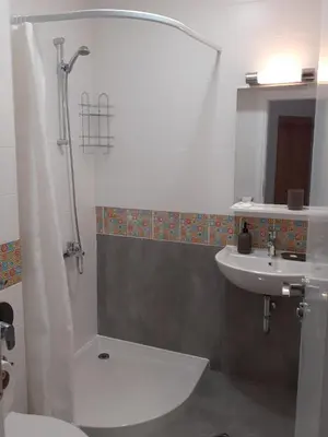 a bathroom with a shower and a toilet and a sink at Комплекс Падалото 
