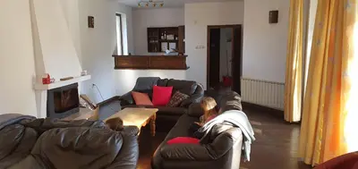 a woman laying on a couch in a living room at Guest House Ela in Dolna Banya