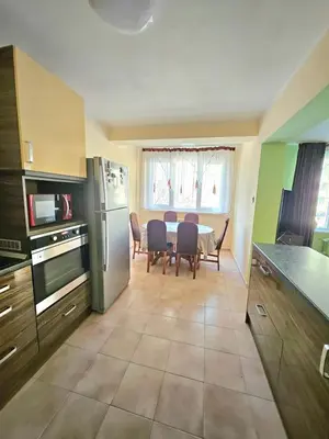 a kitchen and dining room with a table and chairs at Apartment Lozenets in Sofia